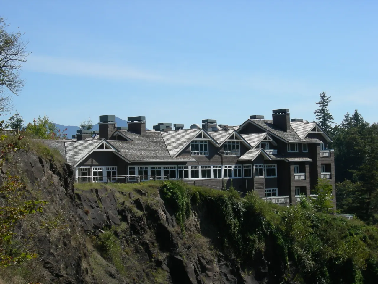 Salish Lodge, a long shingled building, at the edge of the gorge above the falls