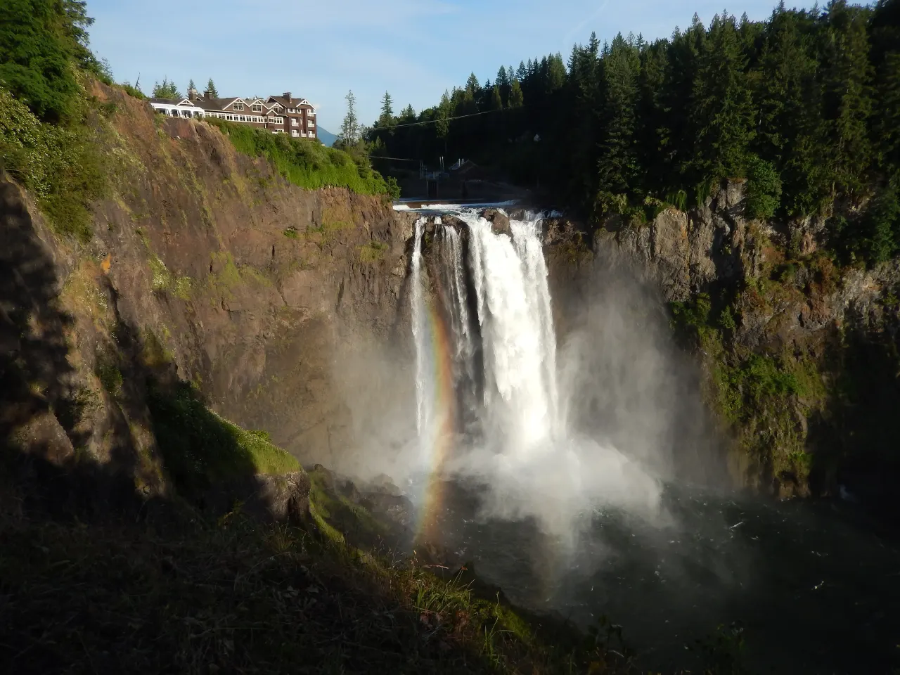 A rainbow arcing through the mist at the base of Snoqualmie Falls